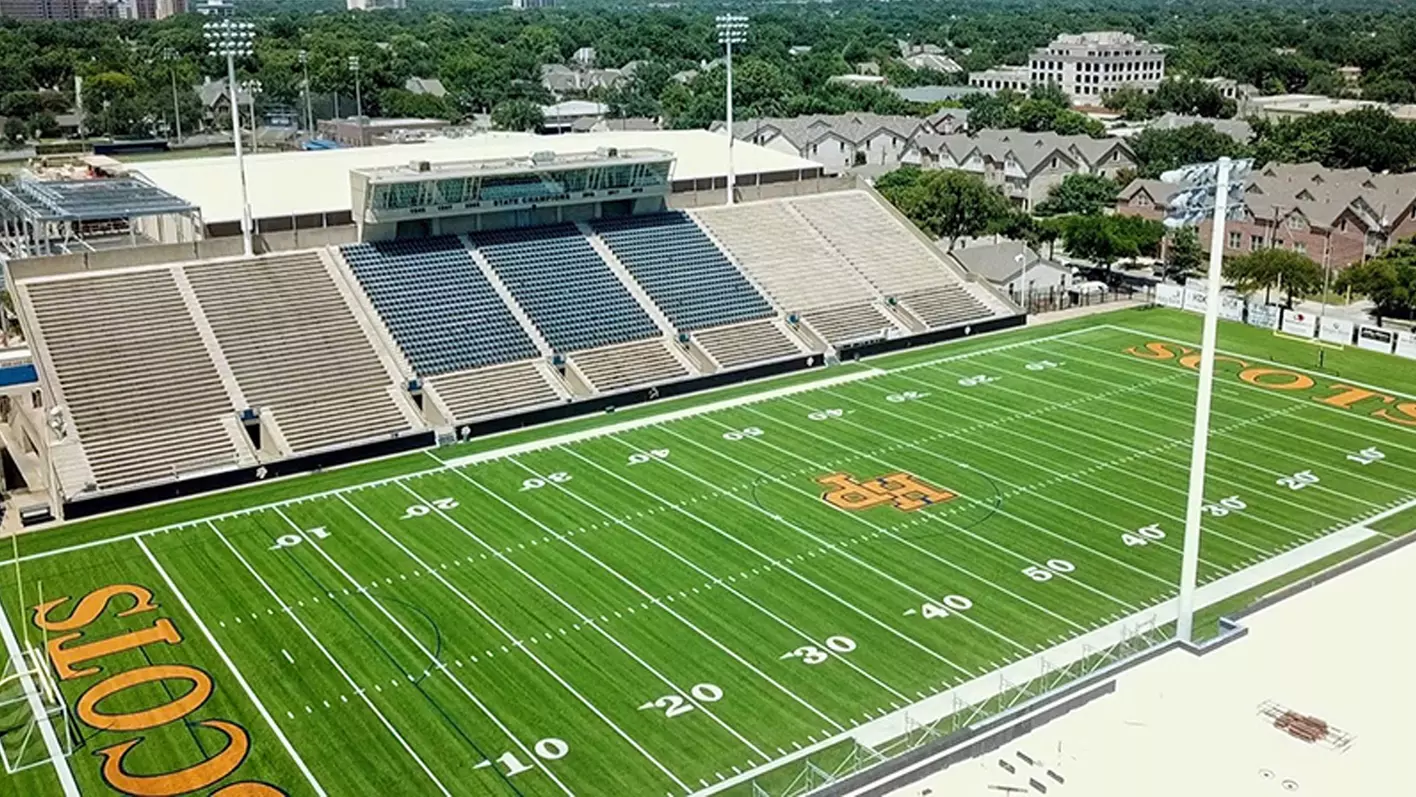 High school football stadium scoreboard and marching band